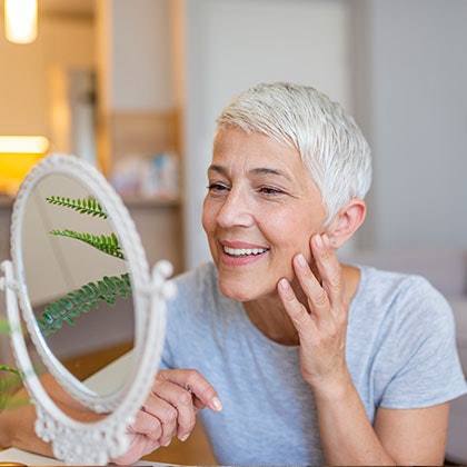 Older woman looking in a mirror