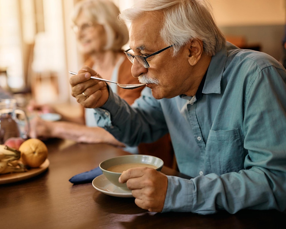 Crown patient eating soup during recovery