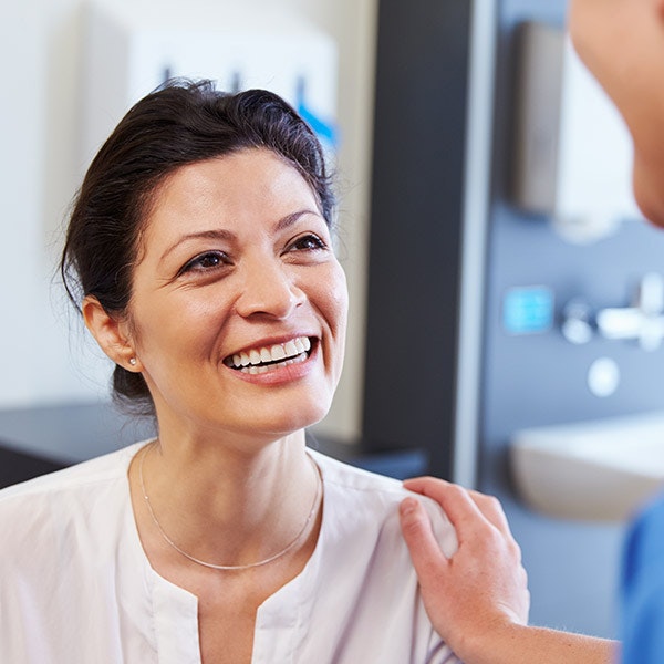 Doctor with hand on shoulder of patient